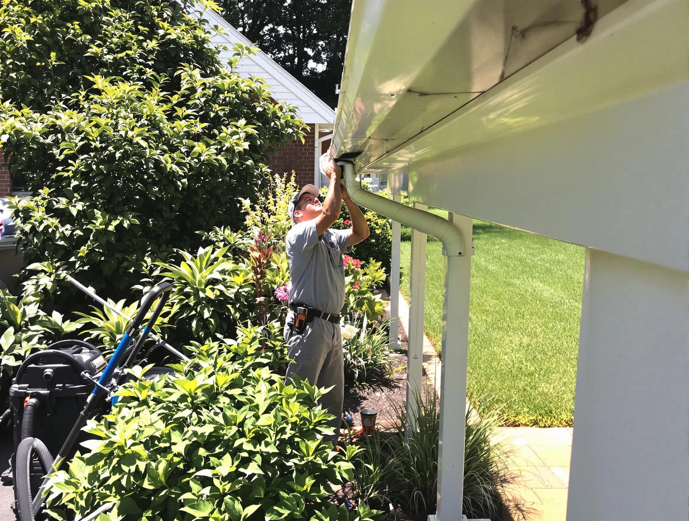 Technician flushing a blockage from a downspout in Middleburg Heights, OH